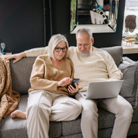 Retiring in Burlington Ontario - Couple Sitting Together on Couch Going Over Retirement Options