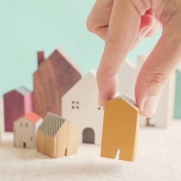 Placing toy houses on table