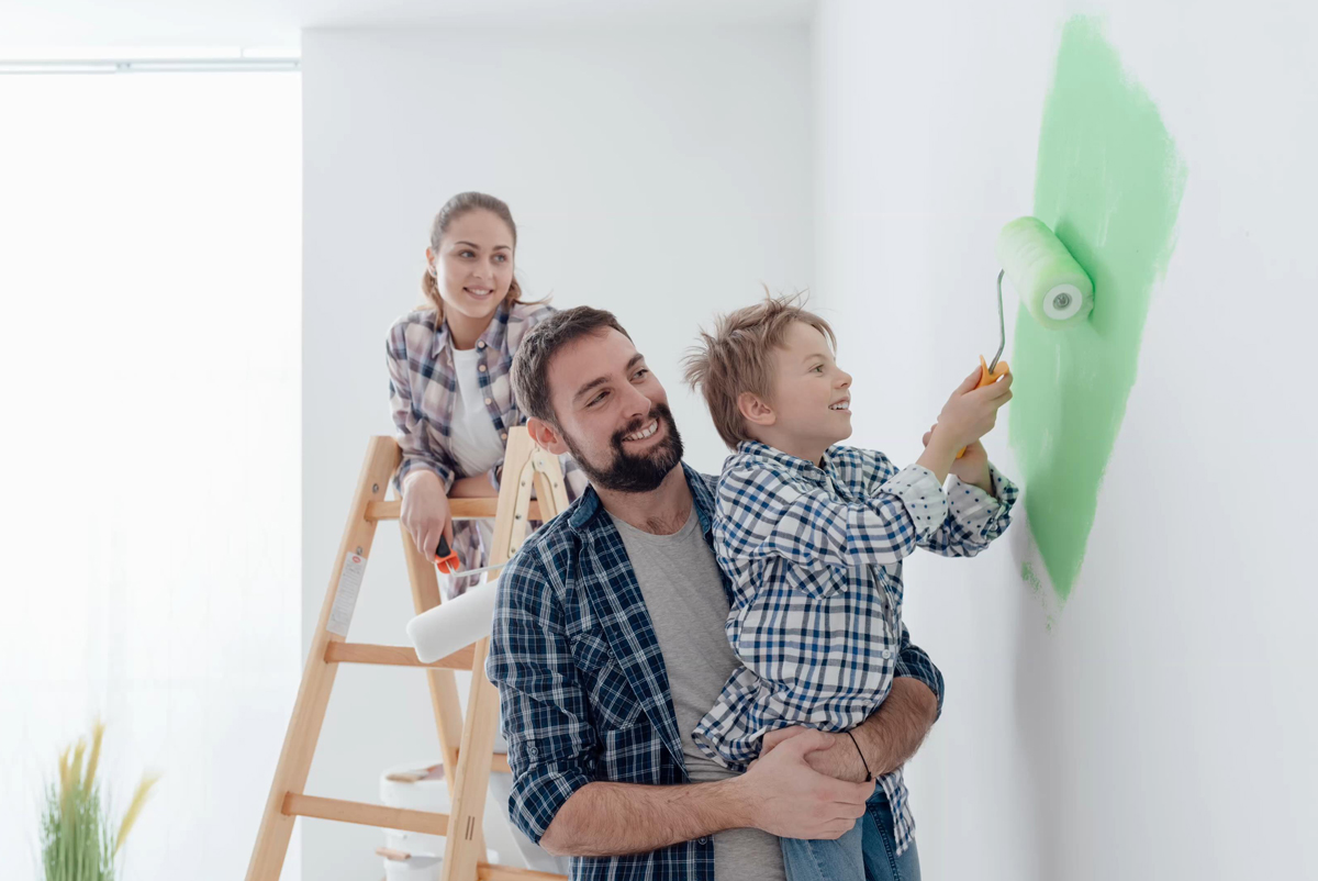 Appleton, WI Couple painting living room with their child