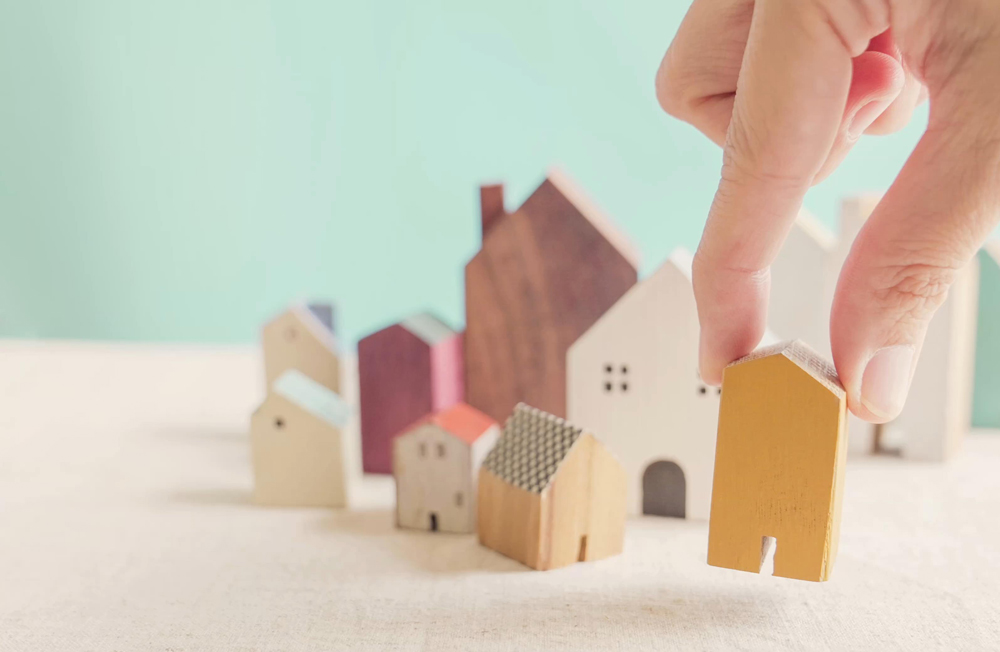Placing toy houses on table