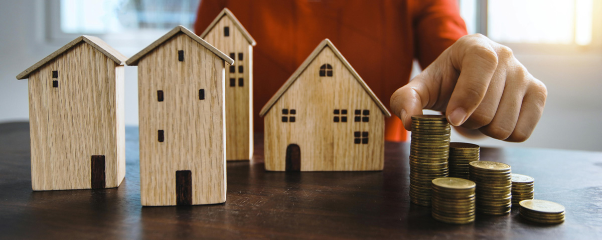 WHEDA, FHA, and Down Payment Assistance represented with model houses and coins on the table