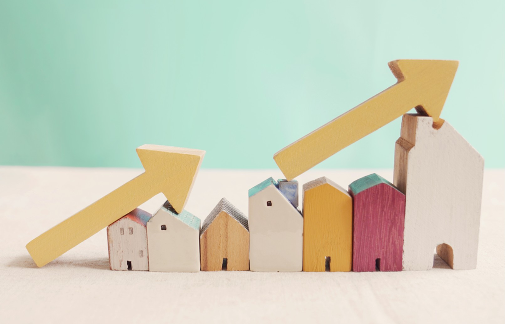 wooden houses with arrow going up