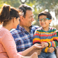 Family Living in Dufferin Grove - Sitting in a Park Smiling Having Fun